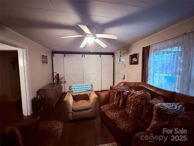 a living room with furniture and a ceiling fan