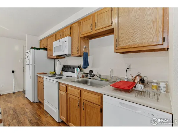 a kitchen with stainless steel appliances granite countertop a sink dishwasher stove refrigerator and cabinets