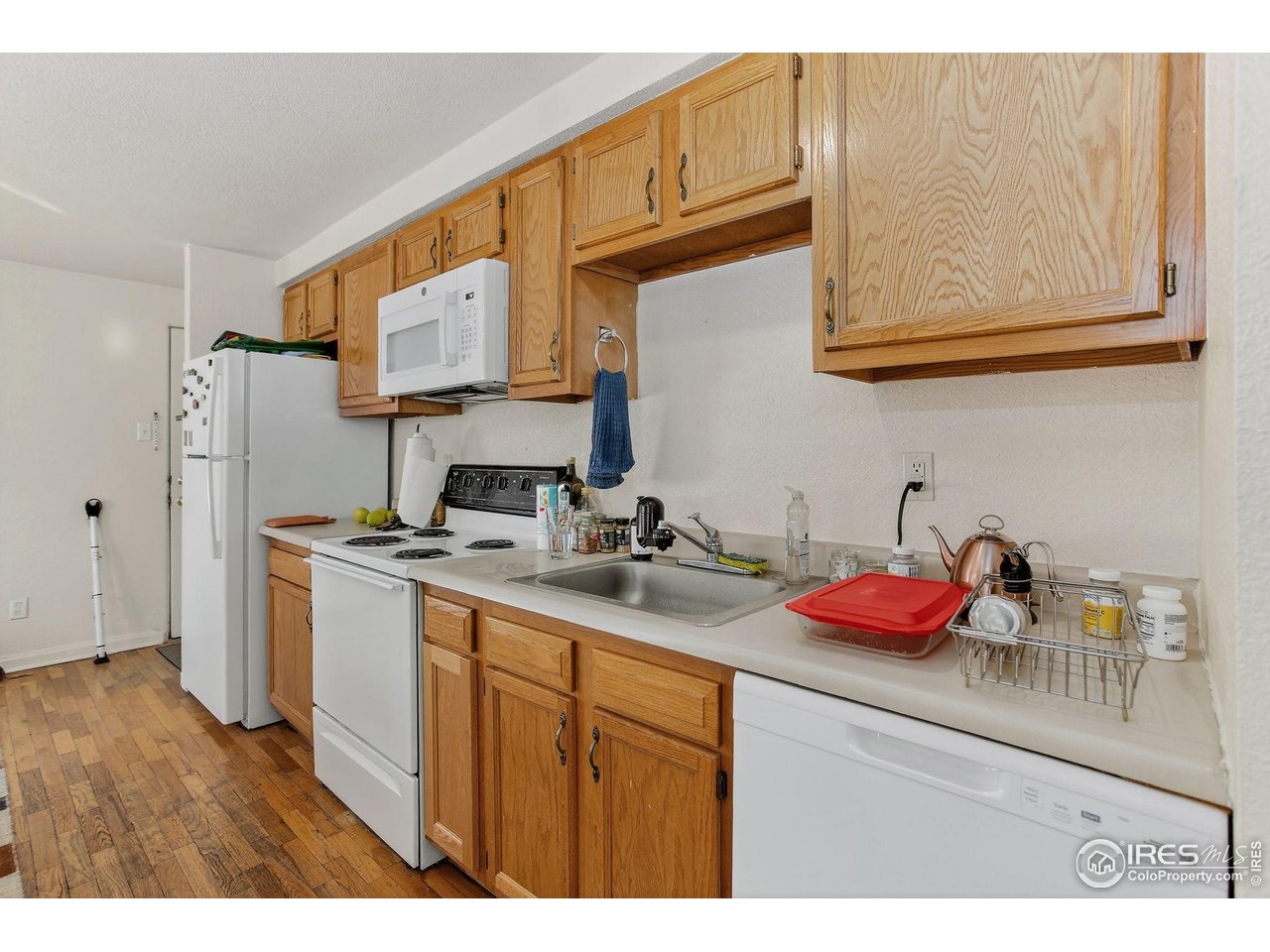 961 16th Street, Unit 5 Boulder, CO 80302 - Photo 5 of 19 a kitchen with stainless steel appliances granite countertop a sink dishwasher stove refrigerator and cabinets