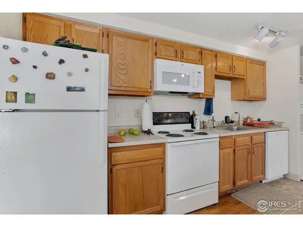 a kitchen with stainless steel appliances a sink a stove a refrigerator a sink and cabinets
