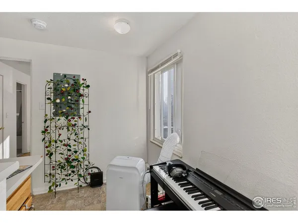 a kitchen with a stove and a white wooden cabinets