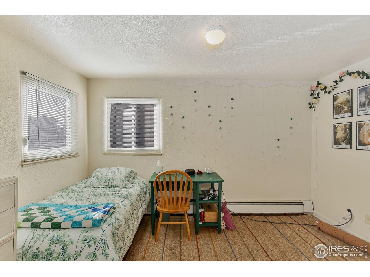 961 16th Street, Unit 5 Boulder, CO 80302 - Photo 9 of 19 a bedroom with a bed and a table in it