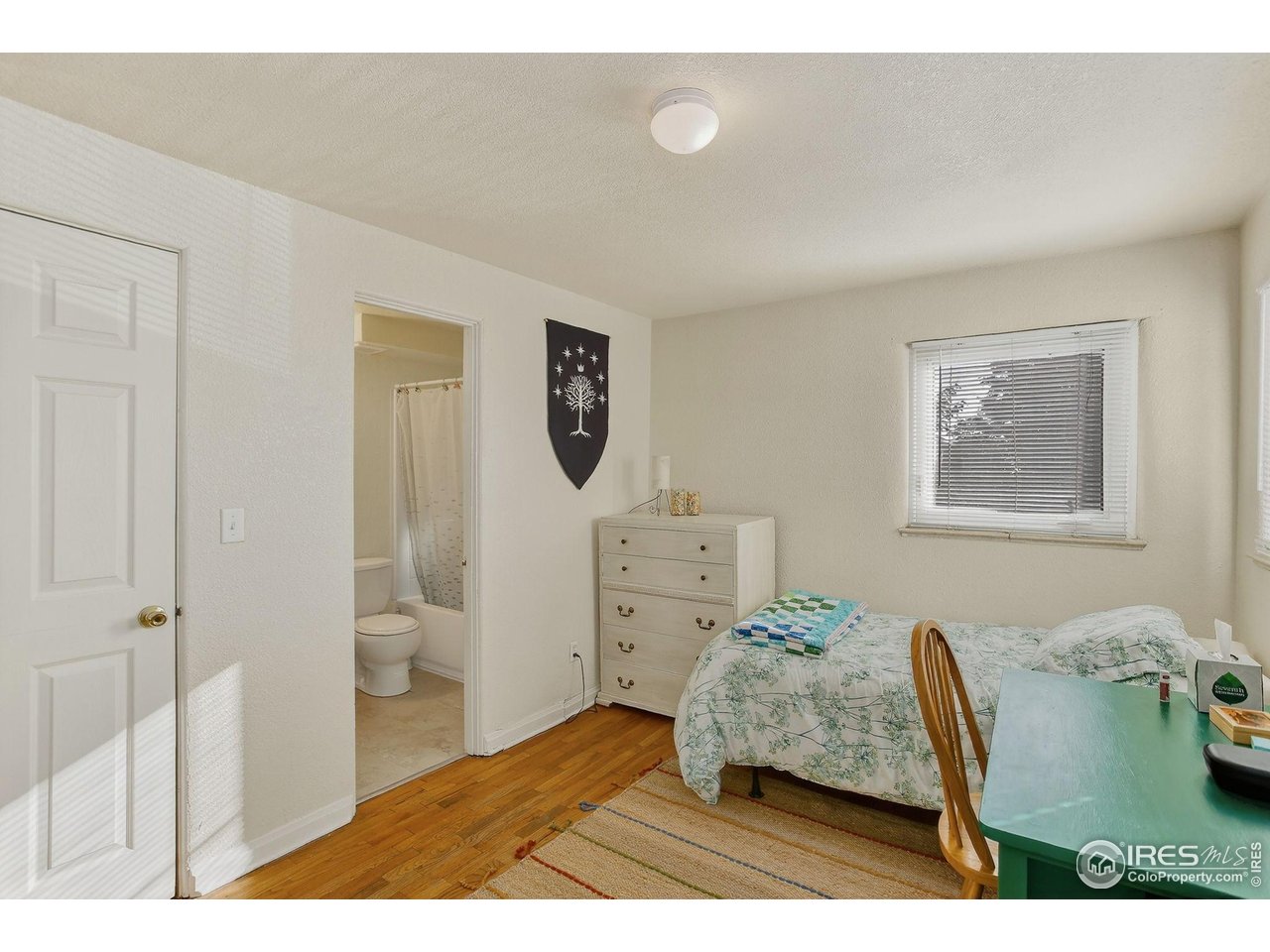961 16th Street, Unit 5 Boulder, CO 80302 - Photo 10 of 19 a bedroom with furniture and a window