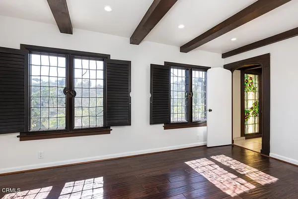 wooden floor in an empty room with a window
