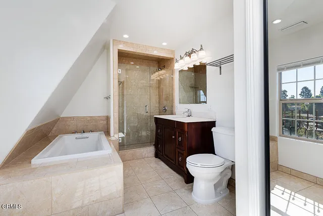 a view of an empty room with wooden floor and stairs