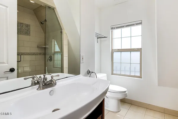 a bathroom with a sink a mirror and a shower