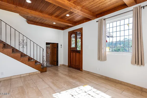 a view of a house with wooden fence
