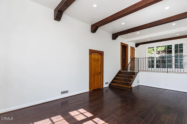 a bathroom with a granite countertop sink and a large window