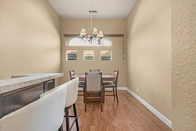 a kitchen with stainless steel appliances granite countertop a sink and cabinets with wooden floor