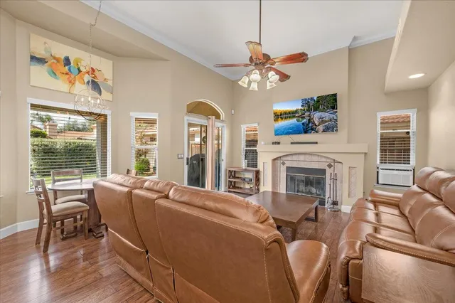 a living room with furniture or wooden floor and a large window