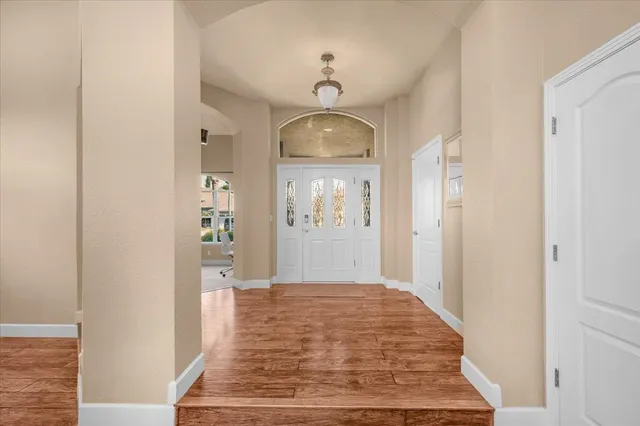 a bedroom with a large bed and a chandelier