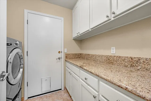 a bathroom with a granite countertop sink a toilet and a large mirror