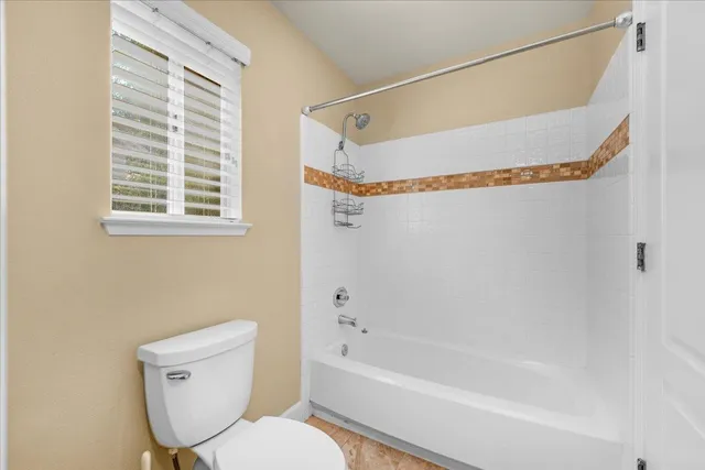 a bedroom with a bed and a refrigerator