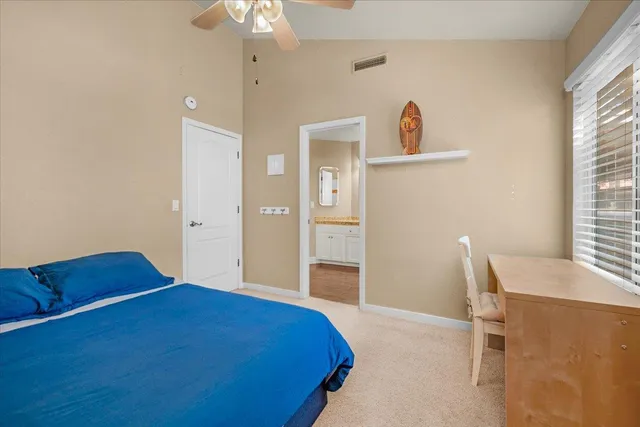 a bathroom with a granite countertop sink a mirror and shower