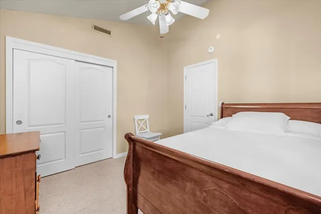 a view of a house with a yard and table and chairs under an umbrella