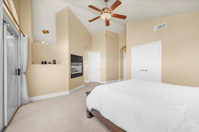 a patio with a table and chairs and potted plants