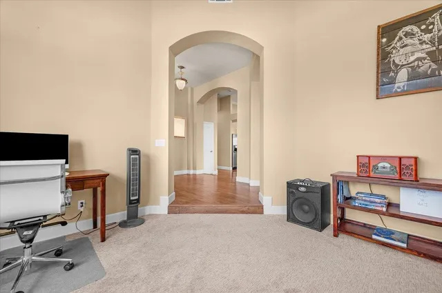 a kitchen with a refrigerator a stove a sink and a dining table with wooden floor