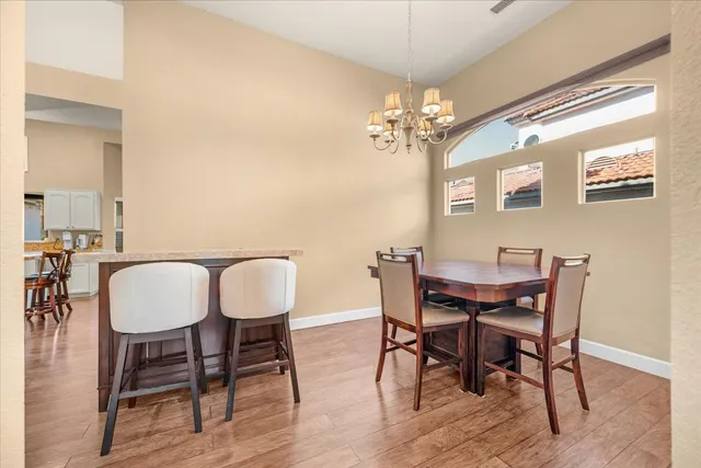 a kitchen with granite countertop a table chairs stove and cabinets