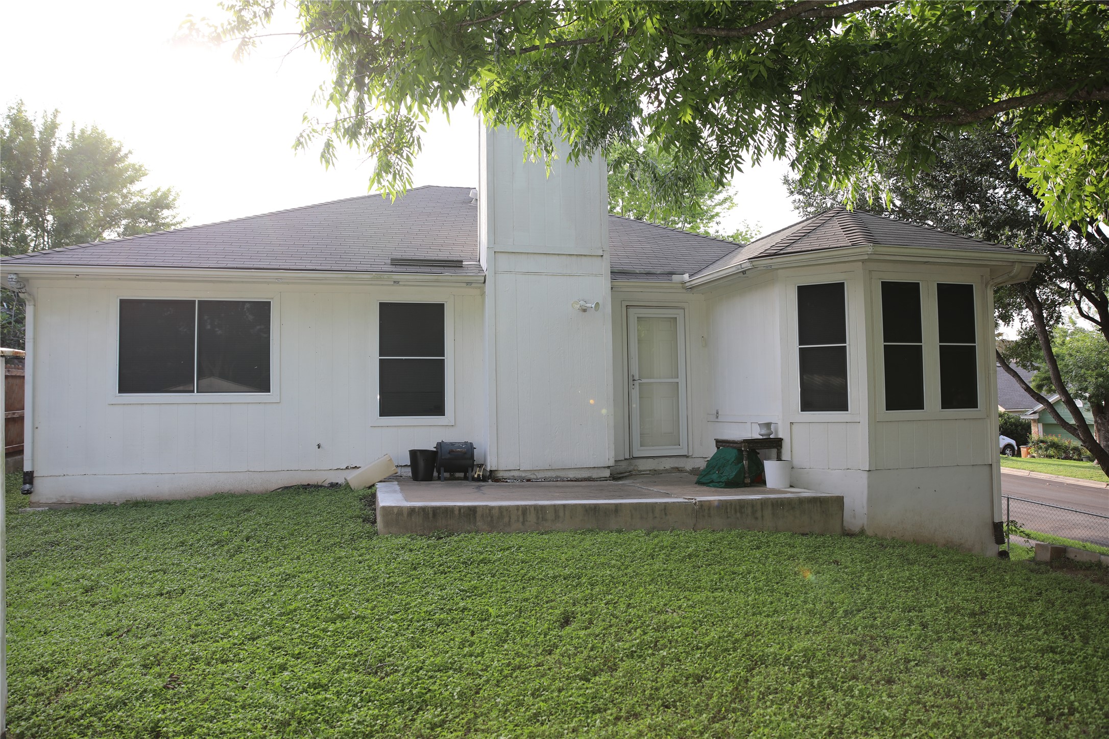 4901 Birch Creek Road Austin, TX 78744 - Photo 7 of 11 A quaint backyard retreat with a concrete patio, perfect for enjoying peaceful afternoons.