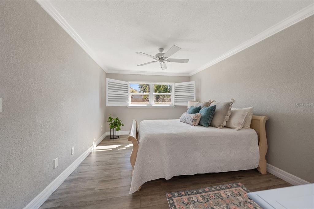 1701 Pinehurst Road, Unit 17G Dunedin, FL 34698 - Photo 11 of 30 a bedroom with a bed lamp and a potted plant