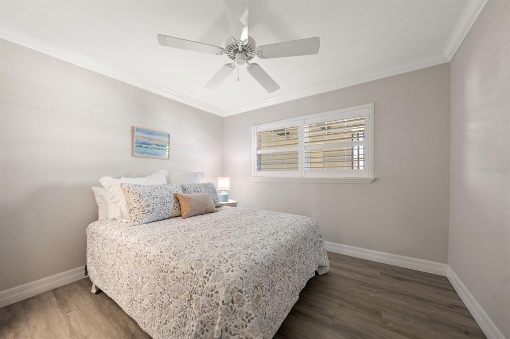 1701 Pinehurst Road, Unit 17G Dunedin, FL 34698 - Photo 14 of 30 a bed room with a bed mirror and a window