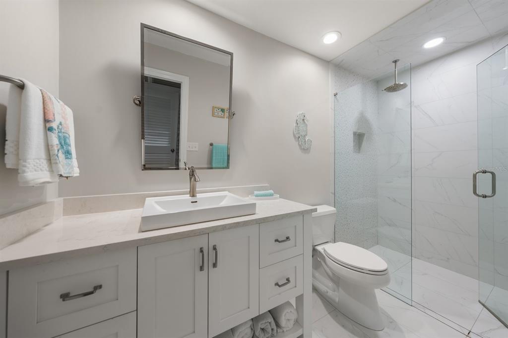 1701 Pinehurst Road, Unit 17G Dunedin, FL 34698 - Photo 16 of 30 a bathroom with a sink a toilet and shower