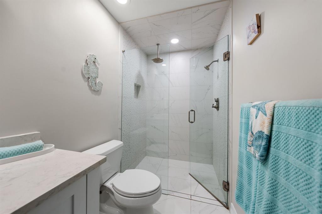 1701 Pinehurst Road, Unit 17G Dunedin, FL 34698 - Photo 17 of 30 a bathroom with a granite countertop sink a toilet and shower