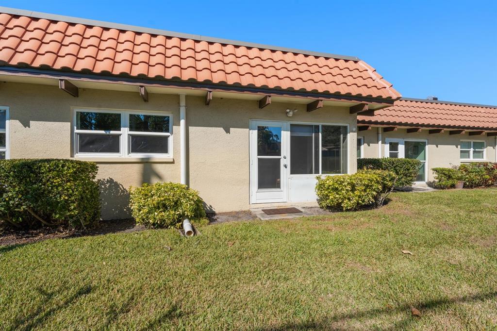 1701 Pinehurst Road, Unit 17G Dunedin, FL 34698 - Photo 19 of 30 a front view of a house with garden