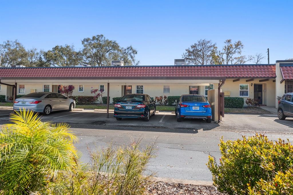1701 Pinehurst Road, Unit 17G Dunedin, FL 34698 - Photo 21 of 30 a view of a cars park in front of a house