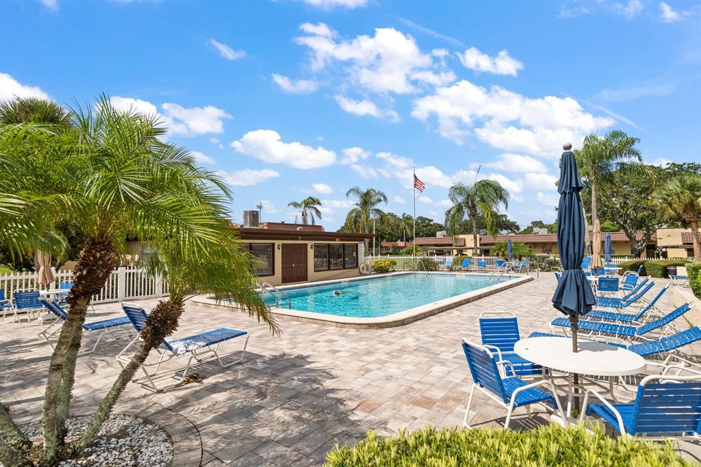 1701 Pinehurst Road, Unit 17G Dunedin, FL 34698 - Photo 24 of 30 a swimming pool with outdoor seating and yard