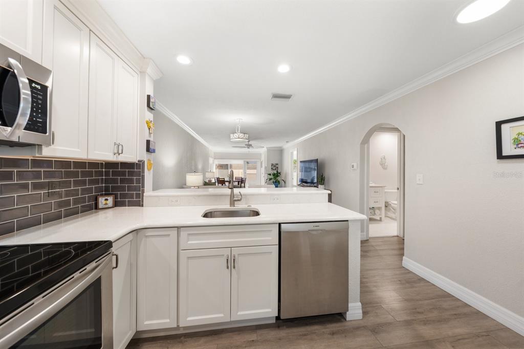 1701 Pinehurst Road, Unit 17G Dunedin, FL 34698 - Photo 4 of 30 a kitchen with a sink cabinets and stainless steel appliances