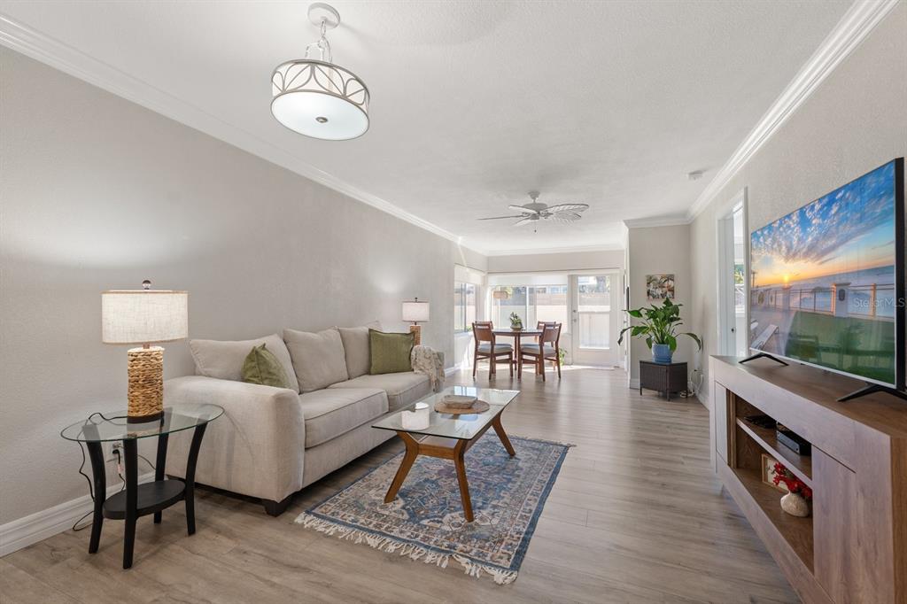 1701 Pinehurst Road, Unit 17G Dunedin, FL 34698 - Photo 7 of 30 a living room with furniture and a flat screen tv