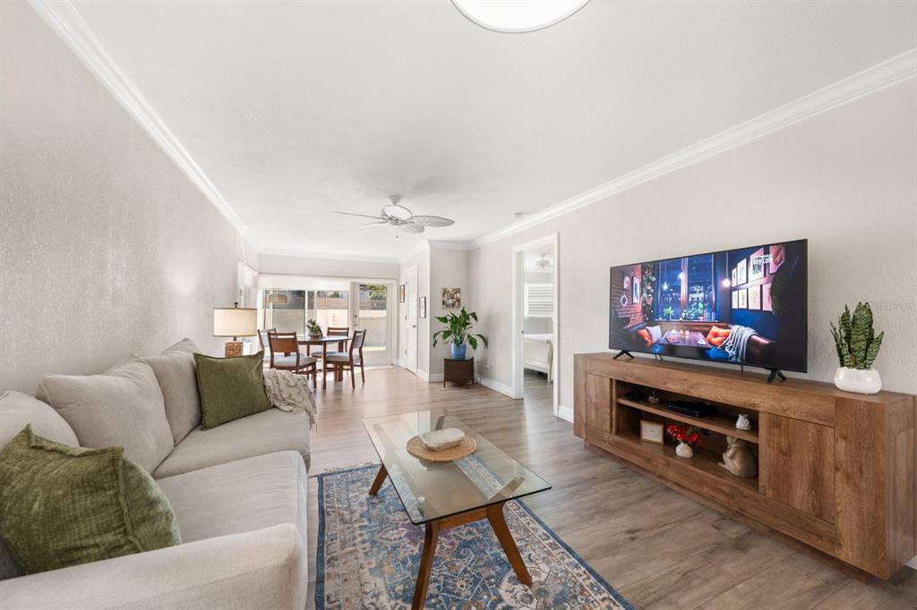 1701 Pinehurst Road, Unit 17G Dunedin, FL 34698 - Photo 8 of 30 a living room with furniture and a flat screen tv