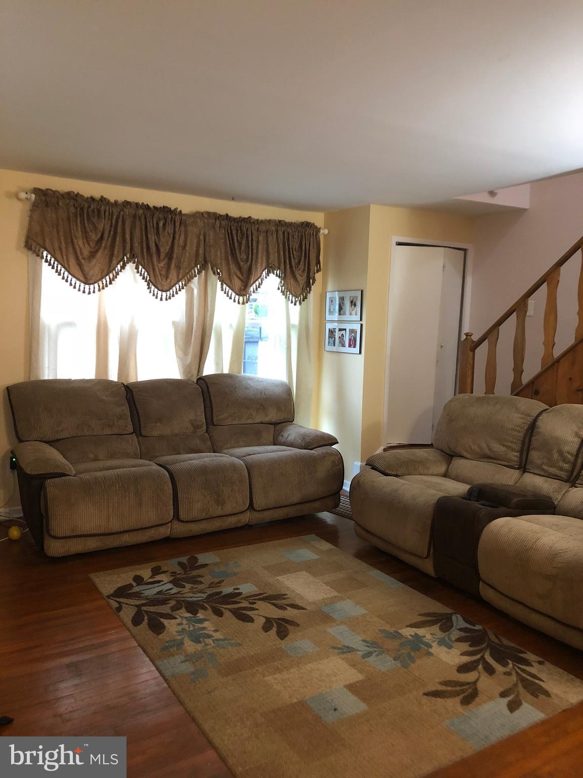 12109 Bluhill Road Silver Spring, MD 20902 - Photo 2 of 6 a living room with furniture and a window
