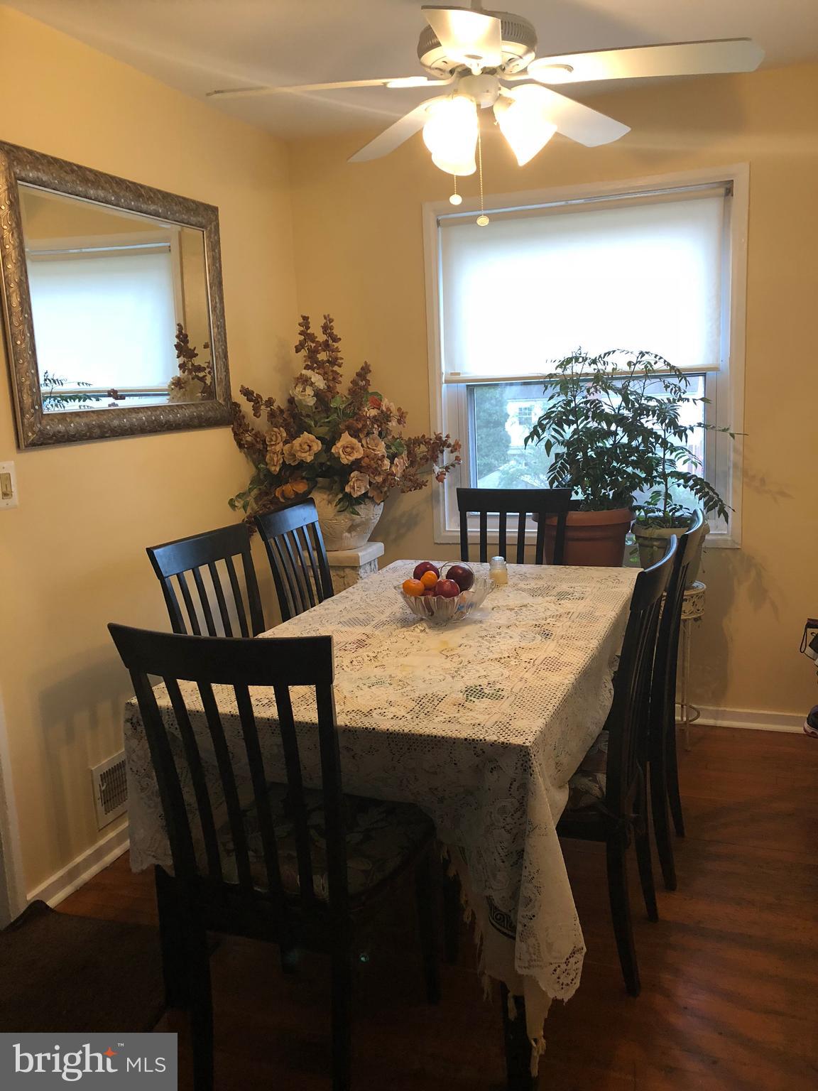 12109 Bluhill Road Silver Spring, MD 20902 - Photo 3 of 6 a view of a dining room with furniture and wooden floor
