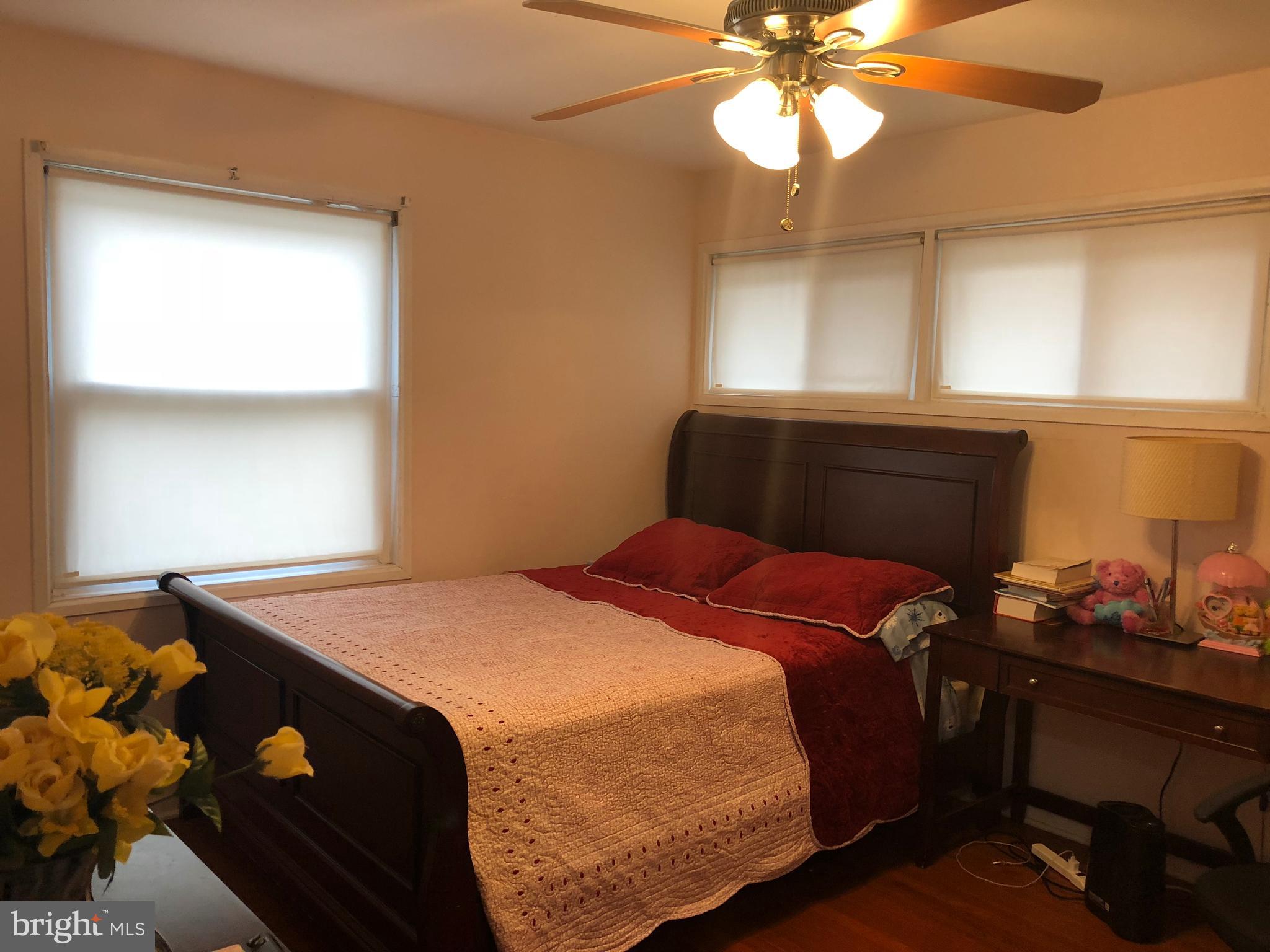 12109 Bluhill Road Silver Spring, MD 20902 - Photo 4 of 6 a bedroom with a bed and a window