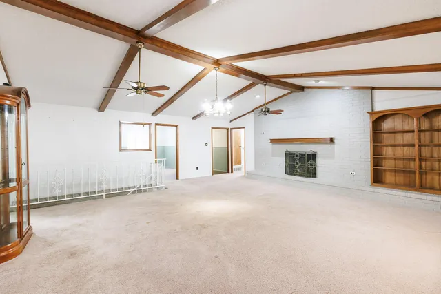 wooden floor in an empty room with a fireplace