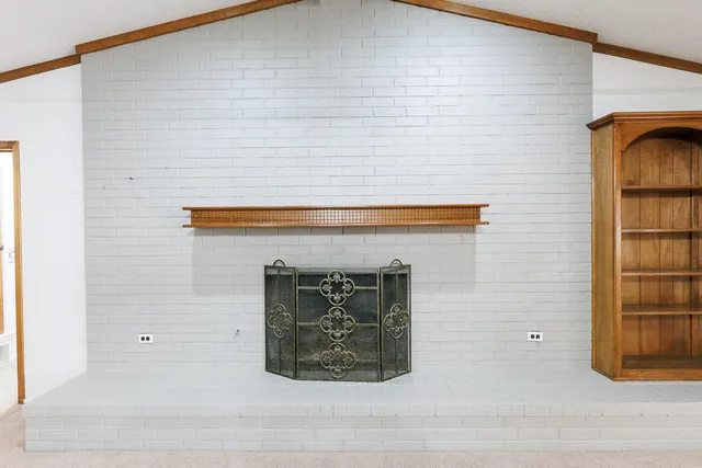 a view of an empty room with a fireplace