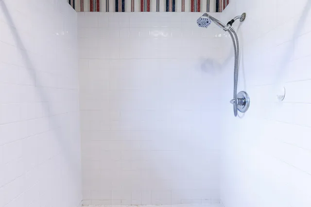 a bathroom with a walk in closet and a window