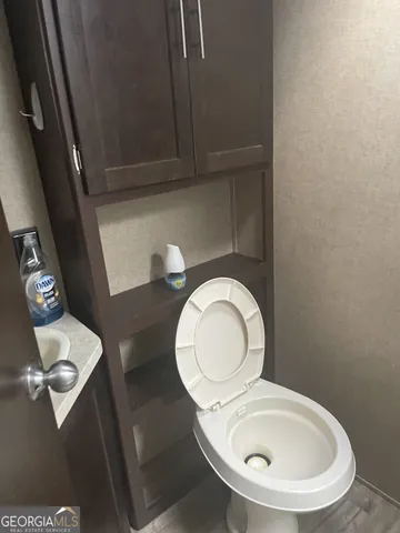a bathroom with a toilet a sink and mirror