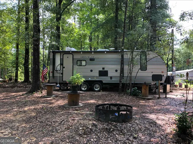 a view of a chair and table in backyard