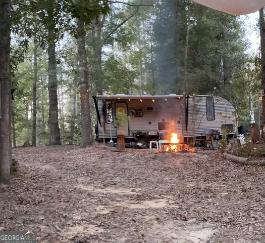 a view of a house with truck parked on the road