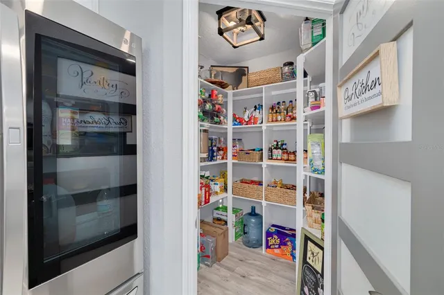 a kitchen with stainless steel appliances kitchen island granite countertop a refrigerator oven a stove a sink and a center island