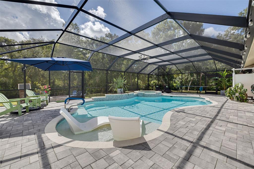 1868 Overview Drive New Port Richey, FL 34655 - Photo 19 of 69 a view of a patio with a table and chairs under an umbrella