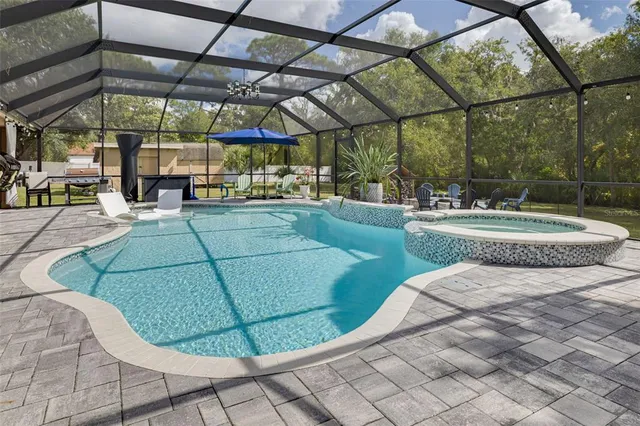 a living room with a flat screen tv and a chandelier