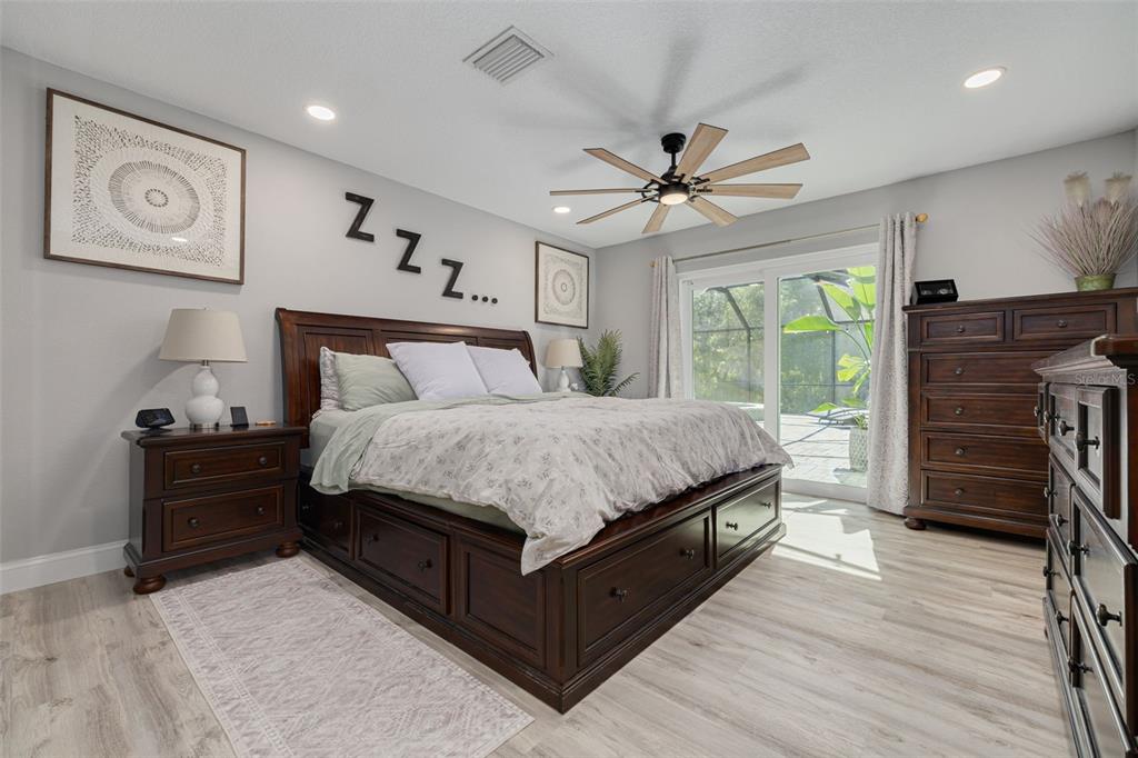 1868 Overview Drive New Port Richey, FL 34655 - Photo 24 of 69 a bedroom with a bed dresser and a flat tv screen