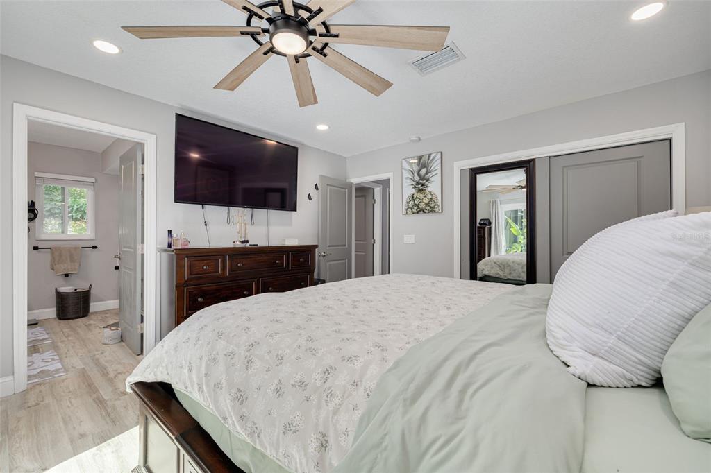1868 Overview Drive New Port Richey, FL 34655 - Photo 26 of 69 a living room with a flat screen tv and a chandelier