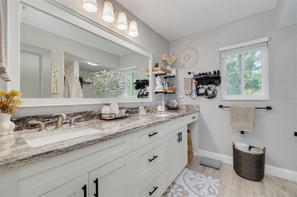 1868 Overview Drive New Port Richey, FL 34655 - Photo 27 of 69 a bathroom with a granite countertop sink mirror and vanity
