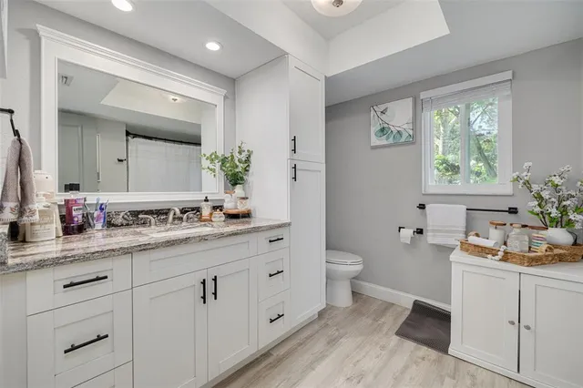 a spacious bathroom with a double vanity sink a mirror and a shower