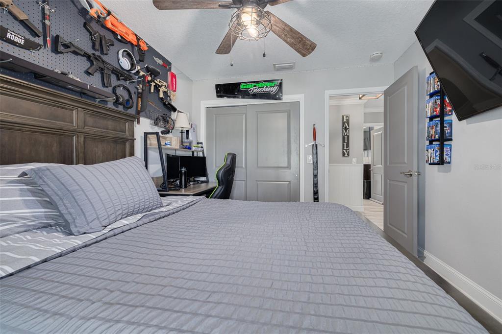 1868 Overview Drive New Port Richey, FL 34655 - Photo 33 of 69 a bedroom with a large bed and a chandelier